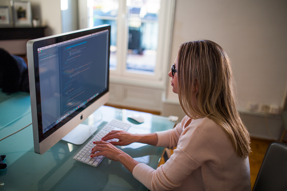 woman coding on computer
